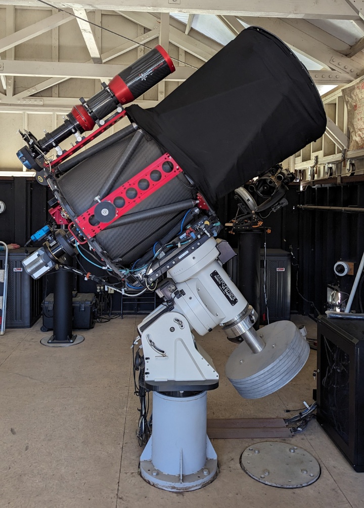 The ATUS 0.6-meter Ritchey-Chrétien telescope, mounted on a German equatorial Astro-Physics 3600GTO mount with a customized polar fork assembly and counterweight shaft. The fast Andor iXon EMCCD camera ("FPI") can be seen at the RC focus; a QSI 616s camera is mounted sideways on the port of a custom built off-axis guider. A QSI 632ws-8 camera is mounted at the piggy-back 130 mm f/6 refractor ("FFI"). The Wide Field Imager (WFI) is not visible in this picture; it is mounted on a third Losmandy dovetail bar (red) hidden by the telescope structure at about the same location as the small stack of steel plates that balance its weight around the declination axis.